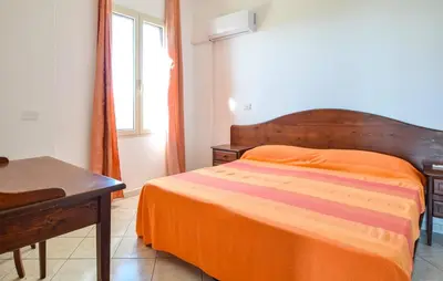 Letto o letti in una camera di Appartamenti a Sa Serra di Orosei