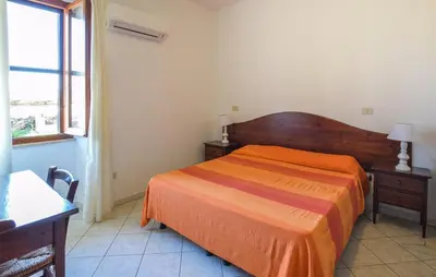 Letto o letti in una camera di Appartamenti a Sa Serra di Orosei