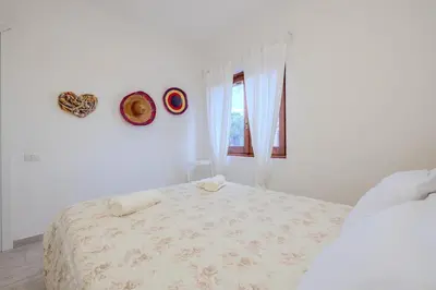 Letto o letti in una camera di Appartamento con 2 camere da letto Baia Turchese