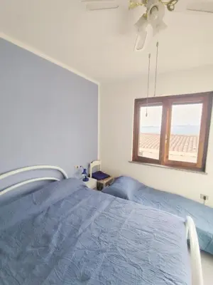 Letto o letti in una camera di Anna, trilocale a Budoni con splendida vista mare