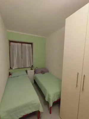 Letto o letti in una camera di Anna, trilocale a Budoni con splendida vista mare