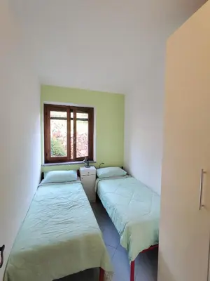 Letto o letti in una camera di Anna, trilocale a Budoni con splendida vista mare