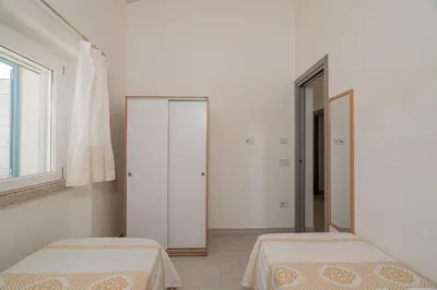 Letto o letti in una camera di Casa vacanza Cala Saccaia