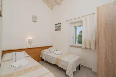 Letto o letti in una camera di Casa vacanza Cala Saccaia