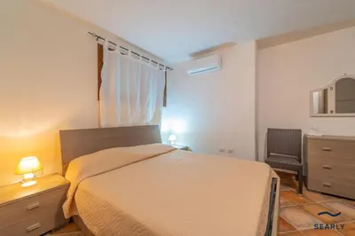 Letto o letti in una camera di Villa Filomena - Appartamento - By Searly