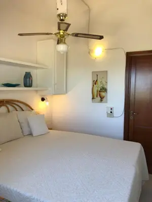 Letto o letti in una camera di Bilocale degli Oleandri vista mare Porto Taverna