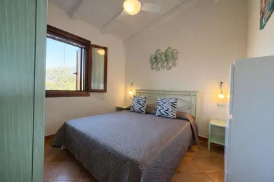 Letto o letti in una camera di Villa Baia Salinedda