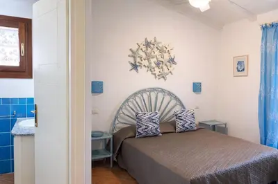 Letto o letti in una camera di Villa Baia Salinedda