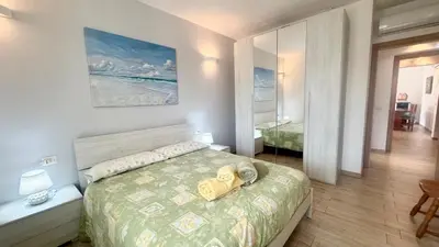 Letto o letti in una camera di Budoni Casa Vacanze - ONDA MARINA