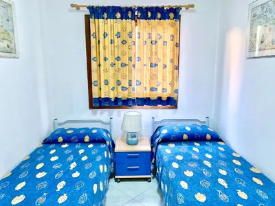 Letto o letti in una camera di Apartment 3 bedrooms, 2 bathrooms in Marinella just 70 mt from the sea