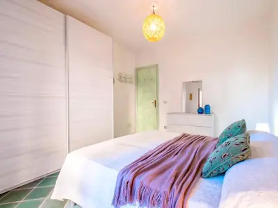 Letto o letti in una camera di Apartment 5 beds with fenced garden in Marinella just 300 mt from the sea