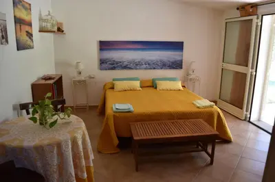 Letto o letti in una camera di Casa vacanze Capo Comino