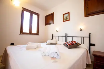 Letto o letti in una camera di Appartamenti Quercia e Olivo