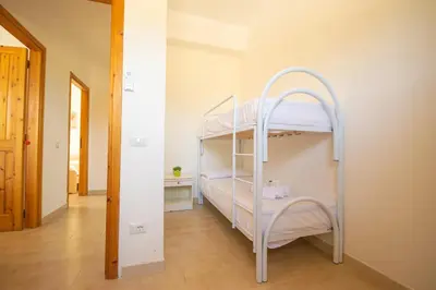 Letto o letti in una camera di Appartamento Posada 6 posti letto con piscina e parcheggio vicino al mare