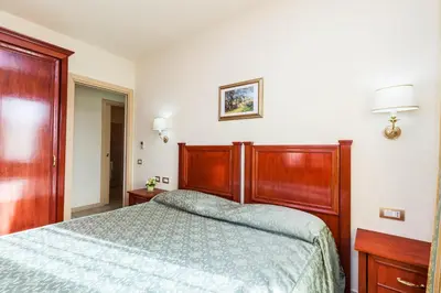 Letto o letti in una camera di Hotel Regina Elena
