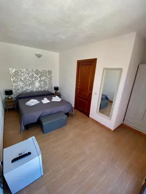 Letto o letti in una camera di QUADRIFOGLIO Affittacamere