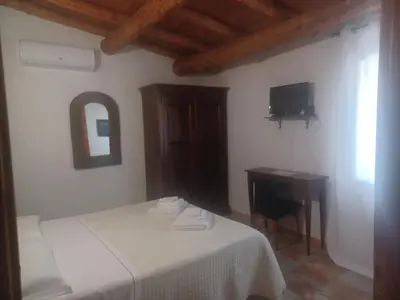 Letto o letti in una camera di B&B Helios Il Tuo Relax In Sardegna