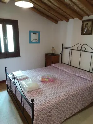 Letto o letti in una camera di Antica Casa dei Contadini di Orosei