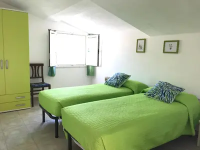 Letto o letti in una camera di Casa Rosa