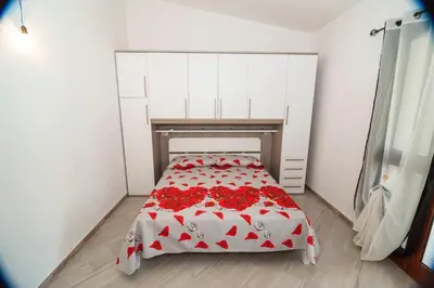Letto o letti in una camera di Sant'Anna Apartments