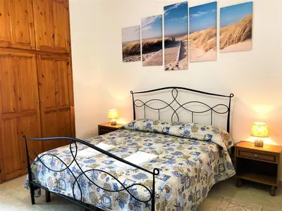 Letto o letti in una camera di Cala Gonone - Casa della Pineta