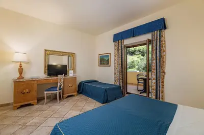 Letto o letti in una camera di Club Esse Palmasera