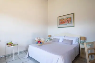 Letto o letti in una camera di Li Suari Club Village