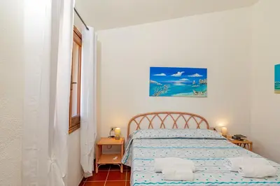 Letto o letti in una camera di Appartamento Cala Paradiso