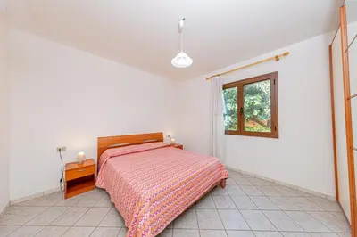 Letto o letti in una camera di Appartamento Residenziale Trilocale 4 posti letto via Sardegna San Teodoro