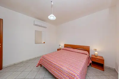 Letto o letti in una camera di Appartamento Residenziale Trilocale 4 posti letto via Sardegna San Teodoro