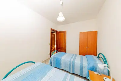 Letto o letti in una camera di Appartamento Residenziale Trilocale 4 posti letto via Sardegna San Teodoro