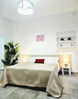 Letto o letti in una camera di Le Arcada - Appartamenti nel cuore del centro storico di Orosei