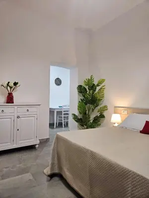 Letto o letti in una camera di Le Arcada - Appartamenti nel cuore del centro storico di Orosei