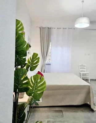 Letto o letti in una camera di Le Arcada - Appartamenti nel cuore del centro storico di Orosei