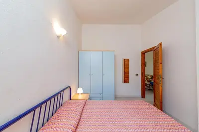 Letto o letti in una camera di Appartamento Trilocale Le Canne 6 posti letto con giardino