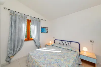 Letto o letti in una camera di Appartamento Trilocale Le Canne 6 posti letto con giardino