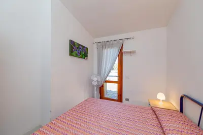 Letto o letti in una camera di Appartamento Trilocale Le Canne 6 posti letto con giardino