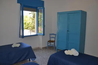 Letto o letti in una camera di Casa indipendente immersa nel verde con vista mare