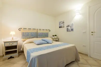 Letto o letti in una camera di Apartment in S'Abba e Sa Pedra complex with pool