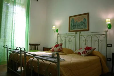 Letto o letti in una camera di b&b Duca d'Aosta