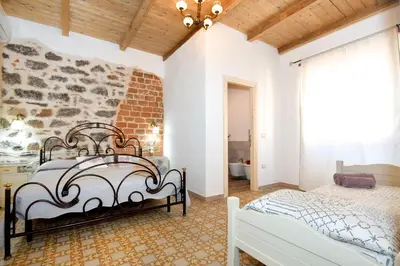 Letto o letti in una camera di B&B Sa domo de sos Massaios