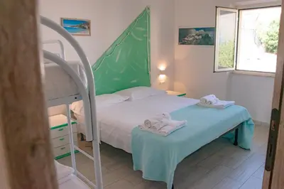 Letto o letti in una camera di Biriola EcoResort Cala Gonone