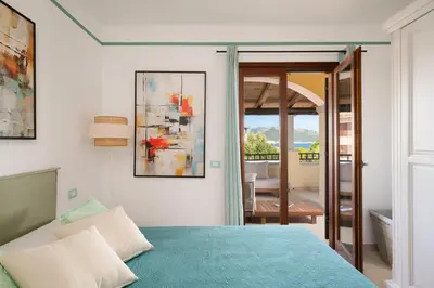 Letto o letti in una camera di Spiaggia Bianca Pedra Rosa - Your House in Sardinia