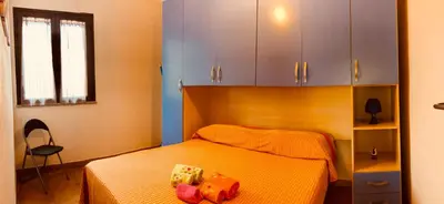 Letto o letti in una camera di appartamento vacanze Sardegna