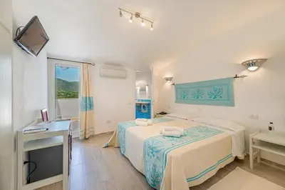 Letto o letti in una camera di Hotel Le Mimose
