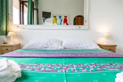 Letto o letti in una camera di Helios Hotel