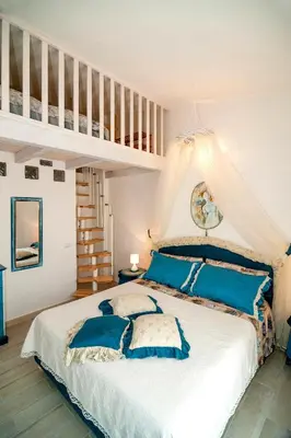 Letto o letti in una camera di Sant'Anna Charming Apartments