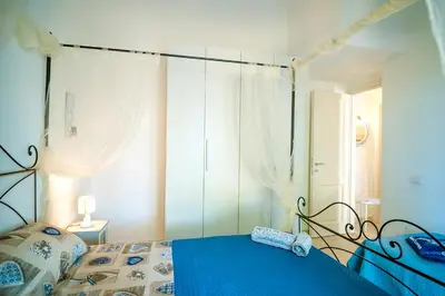 Letto o letti in una camera di Sant'Anna Charming Apartments