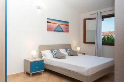 Letto o letti in una camera di villette acquamarina Budoni
