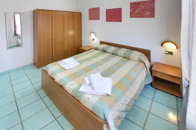 Letto o letti in una camera di Residence Oasi Anfiteatro